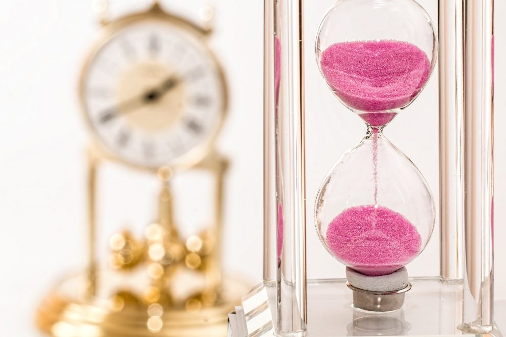 hourglass with pink sand 